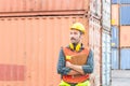 Cheerful factory worker man in hard hat smiling with arms crossed and holding clipboard checklist Royalty Free Stock Photo