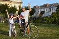 Cheerful family biking in park