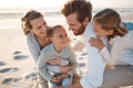 Cheerful family bonding on the beach. Carefree young family on holiday by the beach. Caucasian family enjoying a Royalty Free Stock Photo