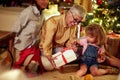 Cheerful family for Christmas in front of a decorated x-mas tree.grandmather and little girl together for Christmas