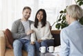 Cheerful Family Couple Talking With Counselor Sitting In Office Royalty Free Stock Photo