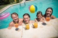 Cheerful family drinking orange juice in swimming pool Royalty Free Stock Photo
