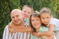 Cheerful family in early fall park Royalty Free Stock Photo