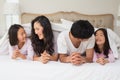 Cheerful family of four lying in bed Royalty Free Stock Photo