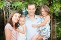 family of four outdoor portrait with two blue eyes daughter child girl