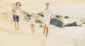 Cheerful family of four running on sandy beach Royalty Free Stock Photo