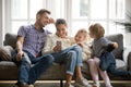 Cheerful family with kids laughing watching funny video on smart Royalty Free Stock Photo
