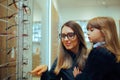 Mother and Daughter Choosing Eyeglasses Frames Together in a Store