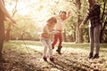 Family playing with jump rope together in park. Royalty Free Stock Photo