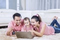Cheerful family playing with laptop together Royalty Free Stock Photo