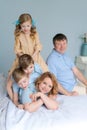 Cheerful family playing together on bed. Parents spend their free time Royalty Free Stock Photo