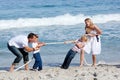 Cheerful family playing tug of war Royalty Free Stock Photo