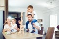 A family plays board games sitting at a table indoors. Royalty Free Stock Photo