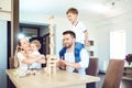 A family plays board games sitting at a table indoors. Royalty Free Stock Photo