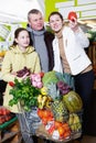 Cheerful family with preteen daughter choosing goods Royalty Free Stock Photo