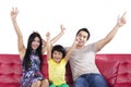 Cheerful family sitting on sofa isolated Royalty Free Stock Photo