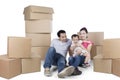 Cheerful family sitting together with boxes Royalty Free Stock Photo