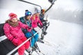 Family in ski lift going to ski terrain Royalty Free Stock Photo