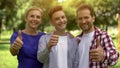 Cheerful family smiling showing thumbs-up, lucrative loans, credits for studying Royalty Free Stock Photo