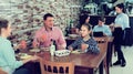 Cheerful family with teenagers having lunch