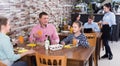 Cheerful family with teenagers having lunch