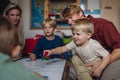 Cheerful family with three kids playing in kids room. Family board game, playtime, having fun together. Royalty Free Stock Photo