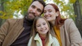 Cheerful family together happy laughing man father woman mother child kid girl little daughter outdoors in park sitting Royalty Free Stock Photo