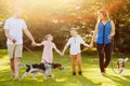 Cheerful family walking together with dogs in park Royalty Free Stock Photo