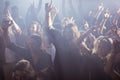 Cheerful fans dancing at nightclub during music festival