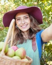 Cheerful farmer harvesting juicy organic fruit in season to eat. Portrait of a happy woman taking selfies while holding Royalty Free Stock Photo