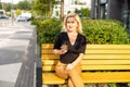 Cheerful fashionable blonde holding coffee outdoors Royalty Free Stock Photo