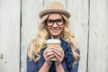 Cheerful fashionable blonde holding coffee outdoors Royalty Free Stock Photo