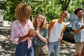 cheerful and fashionable multiethnic students walking