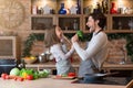 Cheerful father and daughter having fun at kitchen while cooking together Royalty Free Stock Photo