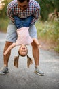 Cheerful father having fun with his little daughter and hold her upside down. Royalty Free Stock Photo