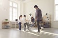 Cheerful father mother and kids daughter and son having fun together at home playing football Royalty Free Stock Photo