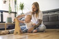 Cheerful father playing with his baby girl on floor at living room Royalty Free Stock Photo