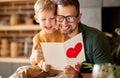 Cheerful father and son celebrating Fathers Day together at home Royalty Free Stock Photo