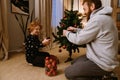 Cheerful father and son decorating Christmas tree at home Royalty Free Stock Photo