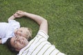 Cheerful Father And Son Lying On Grass