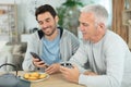 cheerful father son middle age eating homemade cookies Royalty Free Stock Photo