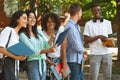Cheerful Female College Students Checking Schedule Of Classes While Standing Outdoors Royalty Free Stock Photo