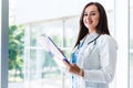 Cheerful female doctor with paperboard Royalty Free Stock Photo
