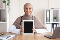 Cheerful female doctor showing digital tablet with blank screen Royalty Free Stock Photo