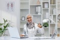 Friendly female doctor in hijab giving thumbs up in clinic Royalty Free Stock Photo