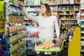 Cheerful female doing restocking for family