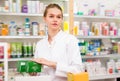 Cheerful female druggist working in pharmacy