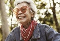 A cheerful female elderly in denim jacket