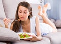 Cheerful female is enjoying tasty green salad