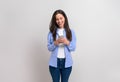 Cheerful female entrepreneur laughing and messaging over mobile phone on isolated white background Royalty Free Stock Photo